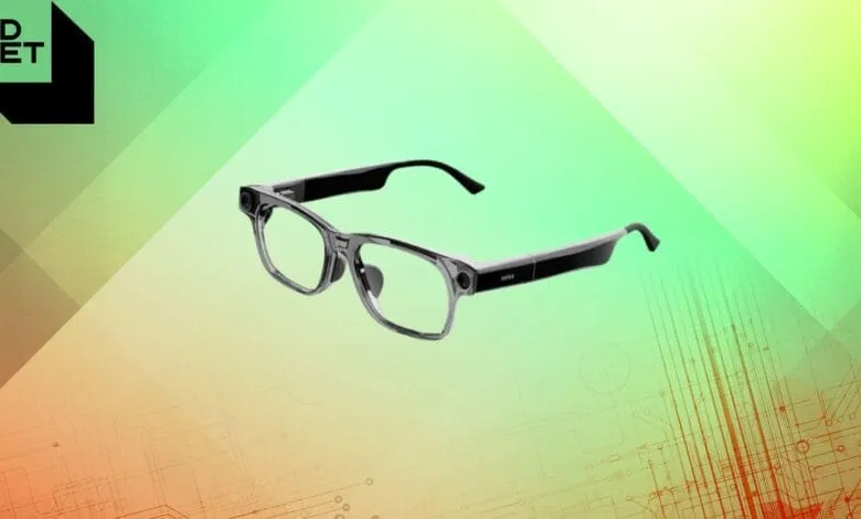 Smart glasses with a sleek, modern design, featuring a small camera and dark gray frames against a green and orange tech background.