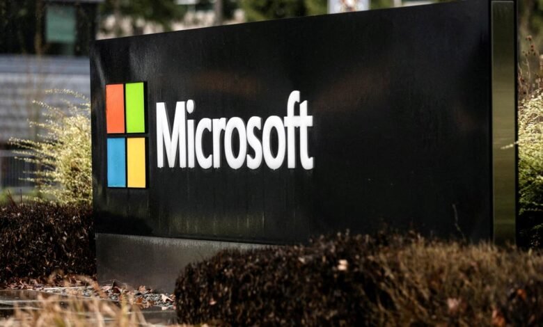 Microsoft logo on a black sign outside a building.