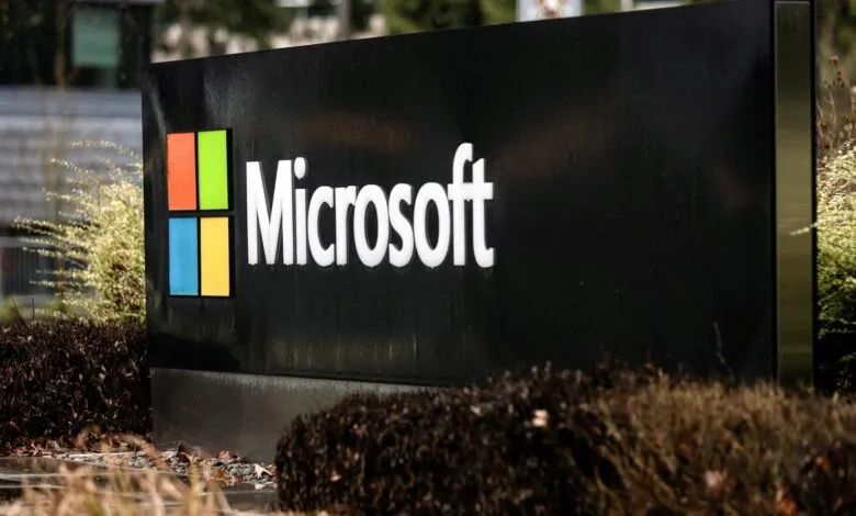 Microsoft logo on a black sign outside a building.