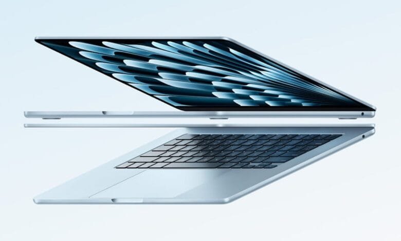 A light blue laptop is shown open at a slight angle, revealing a dark blue screen with an abstract design. The keyboard and trackpad are also visible.