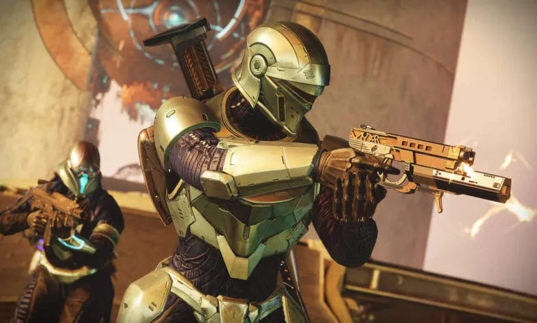 Two futuristic soldiers in gold armor fire weapons, one in sharp focus, the other blurred in the background.