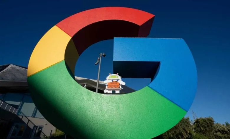 Large Google logo sculpture in vibrant red, yellow, green, and blue, with a small Android robot cutout in the center.