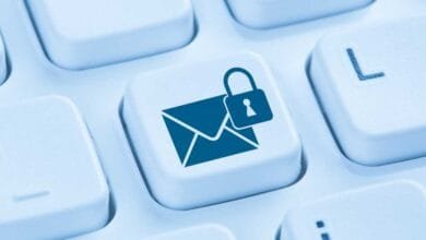 Close-up of a keyboard key featuring a blue email icon with a padlock, symbolizing secure email communication.