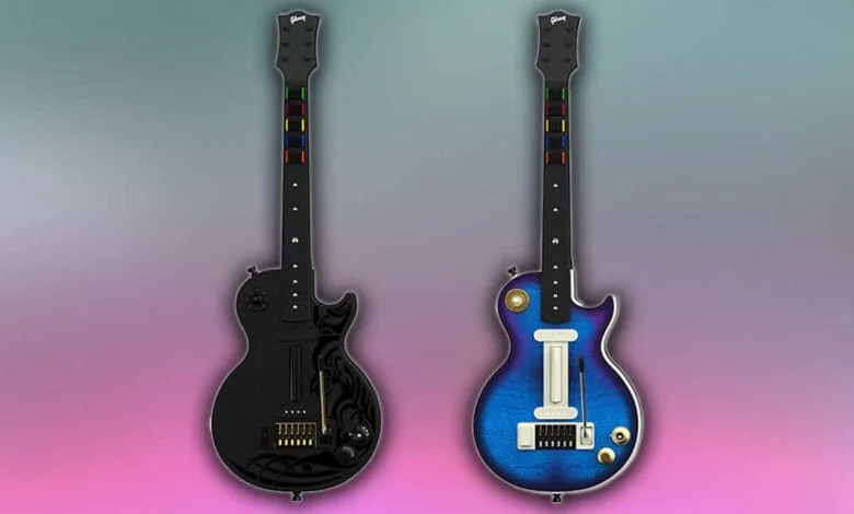 Two electric guitars, one black and one blue, designed for video games, shown against a gradient background.