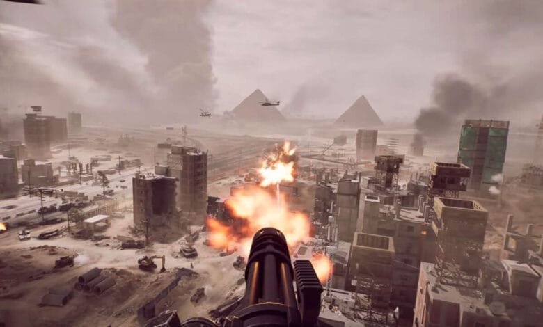 Battlefield 6 gameplay: A first-person view of a player firing a large-caliber weapon at a war-torn city with pyramids in the background.