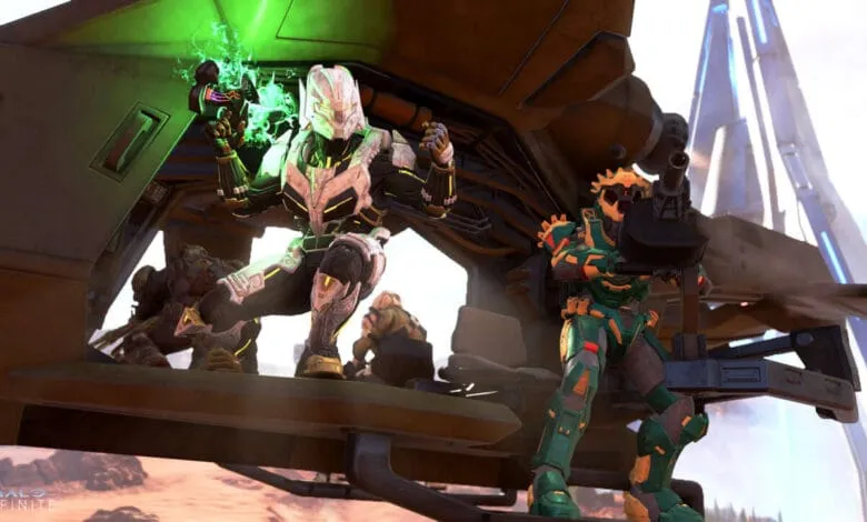 Halo Infinite Spartans in a Warthog, one wielding a green energy weapon.