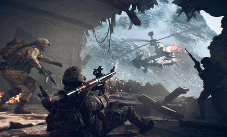 Soldiers in a warzone fire weapons as a helicopter attacks. A snowy mountain is visible through a destroyed building.