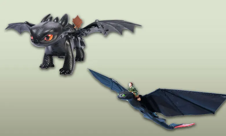 Two Toothless dragon toys from How to Train Your Dragon: one standing, one flying with a miniature rider.
