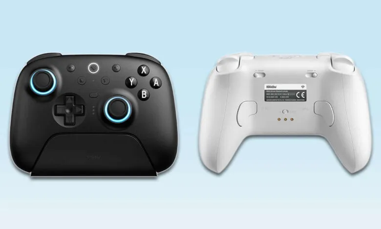 Black and white 8BitDo wireless game controllers shown side-by-side.