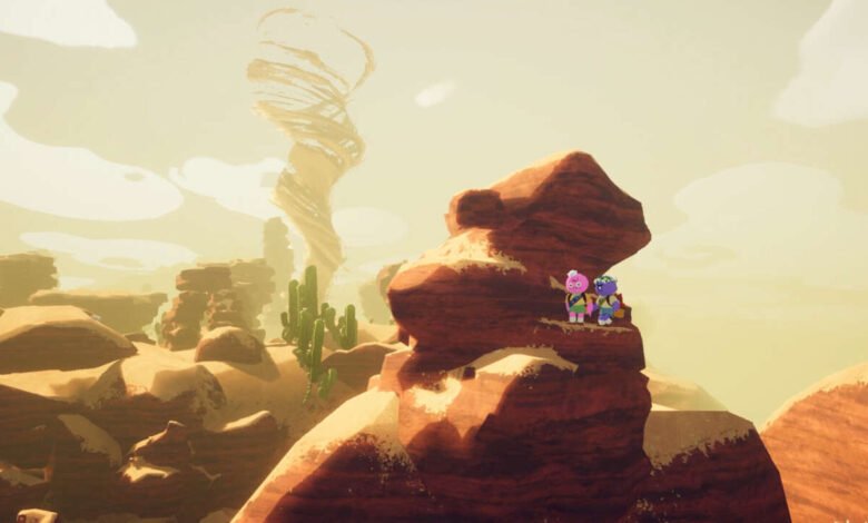 Two cartoon characters stand on a rock overlooking a desert with a large sandstorm.