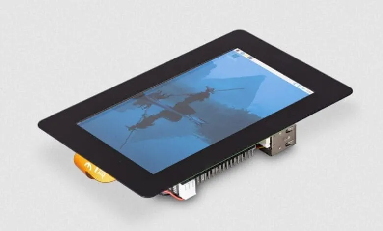 Raspberry Pi 5-inch touchscreen display showing a serene landscape with two figures in a boat.