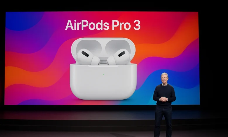 Apple CEO Tim Cook unveils AirPods Pro 3 on stage, shown on a large screen behind him.