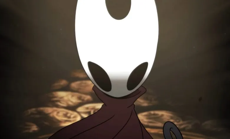 The Knight from Hollow Knight video game, wearing a cloak, stands before a pile of geo.