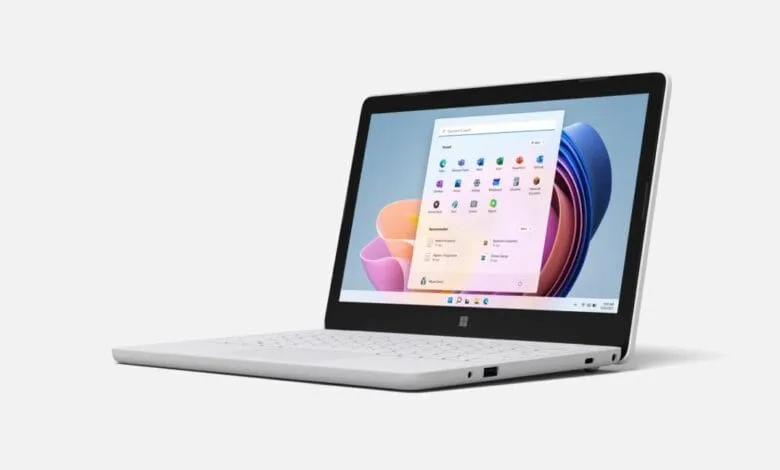 Sleek white laptop displaying the Windows 11 start menu, showcasing various apps and a clean interface.