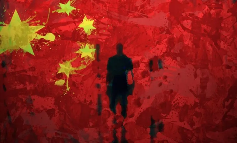 Silhouette of a person against a stylized Chinese flag backdrop with paint splatters.