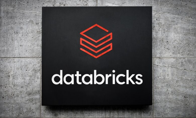 Databricks logo on a black sign mounted on a concrete wall.