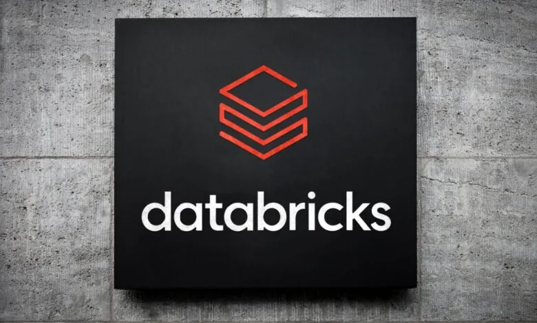 Databricks logo on a black sign mounted on a concrete wall.