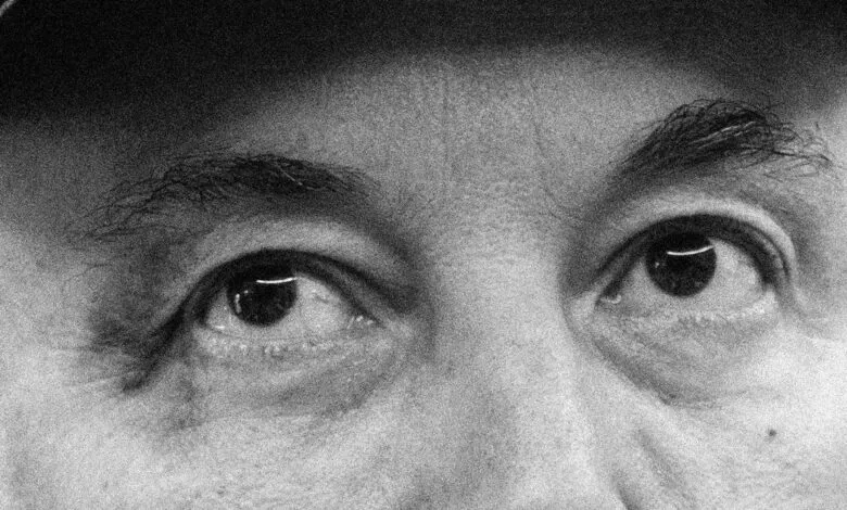 Extreme close-up of a person's eyes and eyebrows in black and white.