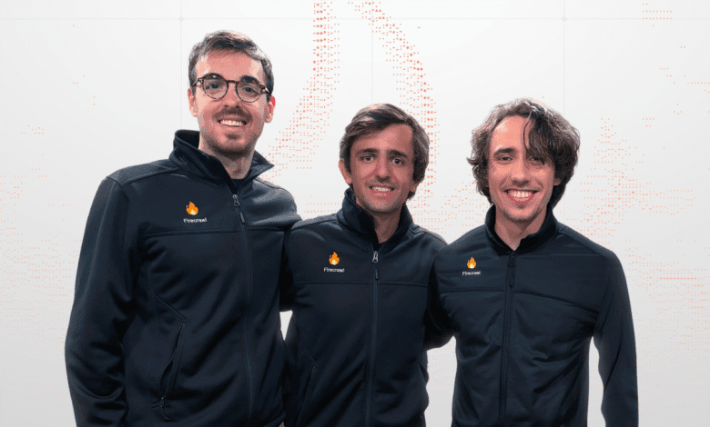 Three smiling men in black Firecrawl jackets stand together against a light gray background.