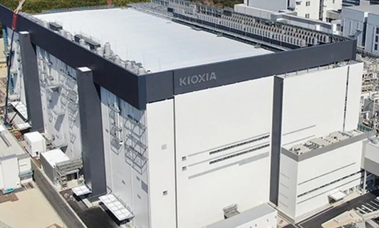 Aerial view of Kioxia's new data center, a large, modern building with a flat roof and the Kioxia logo prominently displayed.