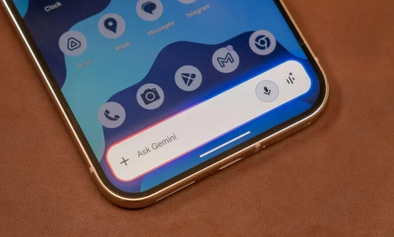 Close-up of a smartphone displaying the Google Gemini AI interface, showing various app icons and a search bar.