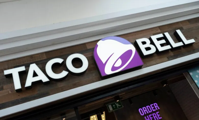 Taco Bell restaurant exterior sign with logo and 'Order Here' sign.