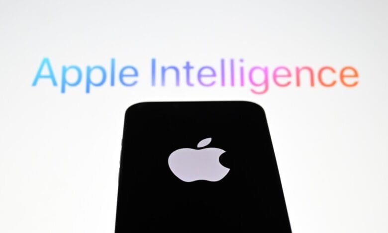 Apple logo on a black phone silhouetted against a blurred background displaying 'Apple Intelligence' in a colorful gradient.