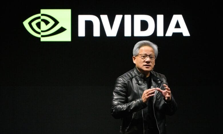 Jensen Huang, CEO of Nvidia, speaks at a presentation with the Nvidia logo in the background.