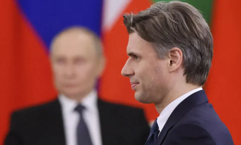 Close-up profile view of Min Aung Hlaing, Myanmar's Prime Minister, with Vladimir Putin blurred in the background.