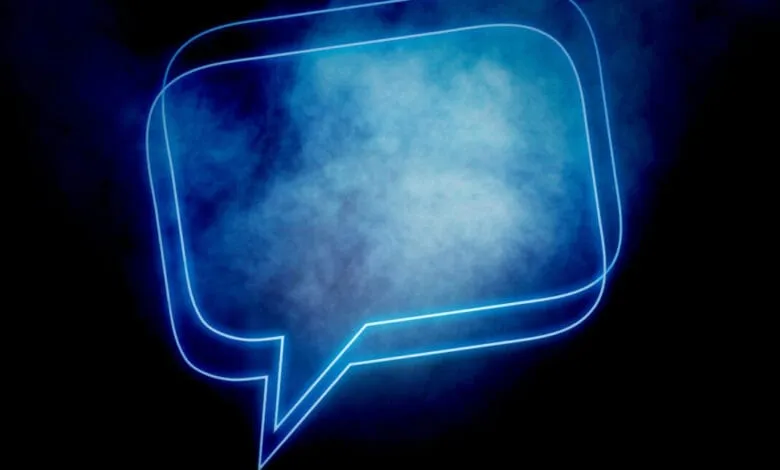 Glowing blue neon speech bubble on a dark background with smoky effect.