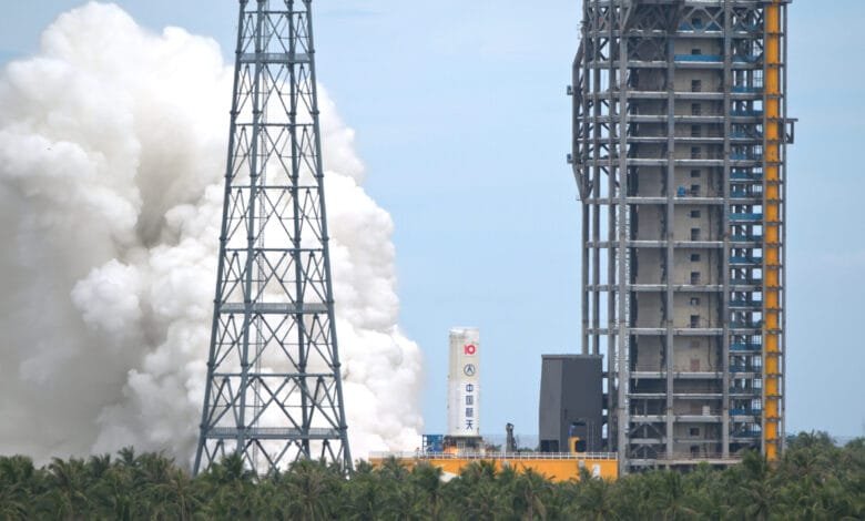 China's Long March-10 rocket undergoing a static fire test, emitting a large plume of white smoke.