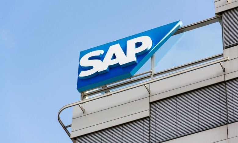 The SAP logo on a modern building against a clear blue sky.