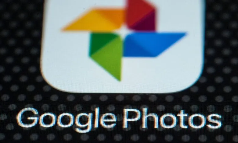 Close-up of the Google Photos app icon and text on a dark mobile screen.