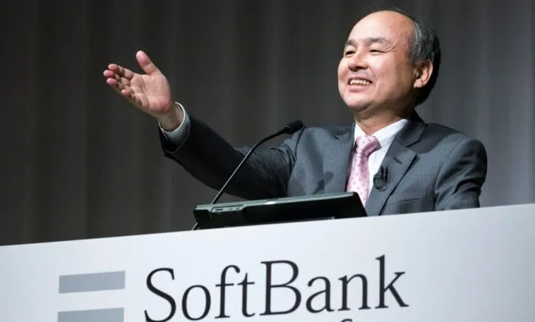 Masayoshi Son, CEO of SoftBank Group, smiles and gestures while speaking at a podium.