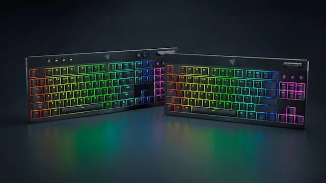 Two Razer gaming keyboards with vibrant RGB backlighting, displayed on a dark surface.