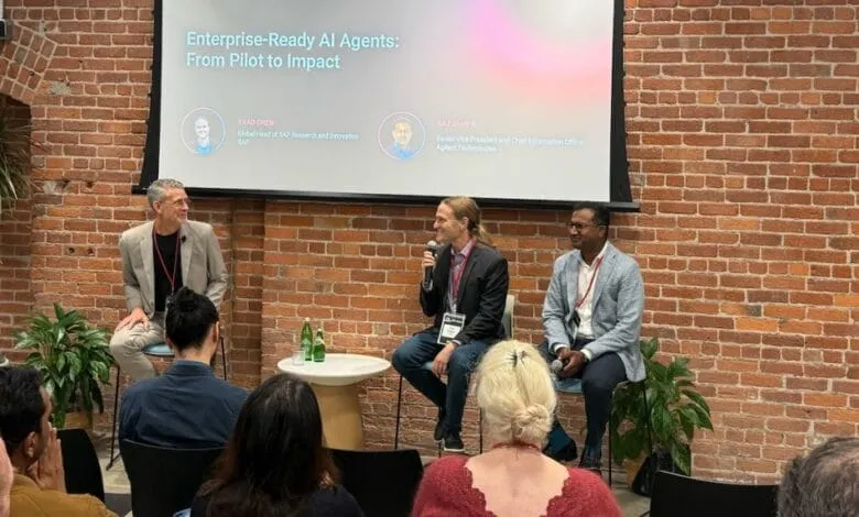 Panel discussion on enterprise-ready AI agents, featuring Yaad Oren and Raj Jampala against a brick wall.
