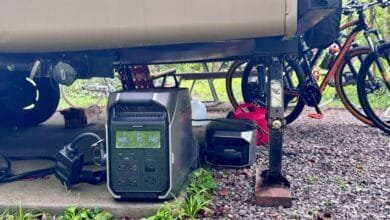 Portable power stations under an RV, near bikes. Perfect for off-grid camping.