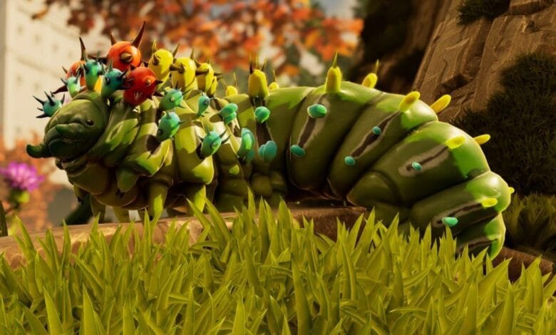 A vibrant, cartoonish caterpillar-like creature with colorful spikes and markings crawls through lush green grass.