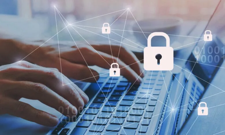 Hands typing on a laptop keyboard with digital lock icons and binary code overlaid, symbolizing online security.