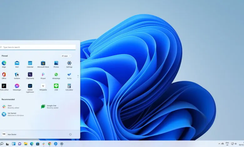 Windows 11 start menu with pinned and recommended apps, showcasing a blue abstract background.