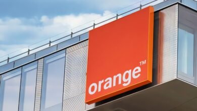 Orange telecommunications logo on a modern building.