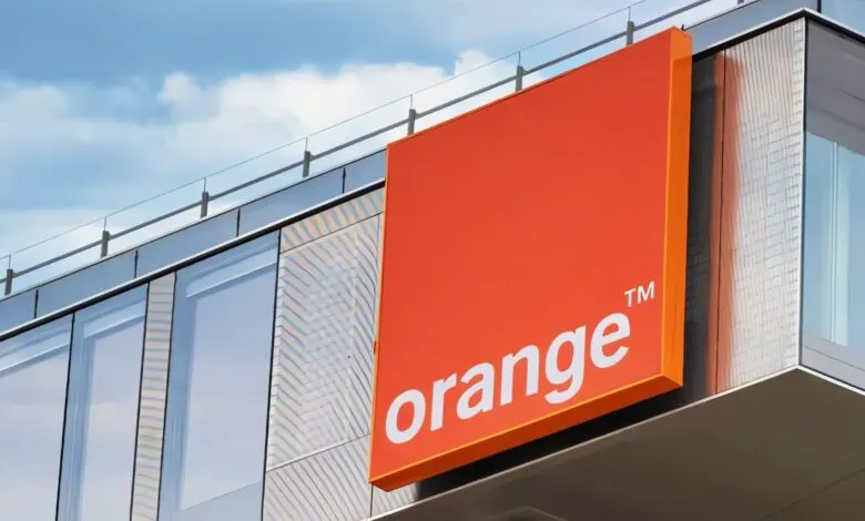 Orange telecommunications logo on a modern building.