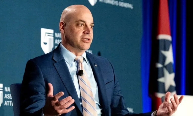 Pennsylvania Attorney General Dave Sunday speaks at a conference, gesturing with his hands.