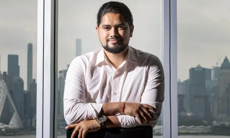 Pukar Hamal, CEO of SecurityPal, sits confidently in an office with a city backdrop.