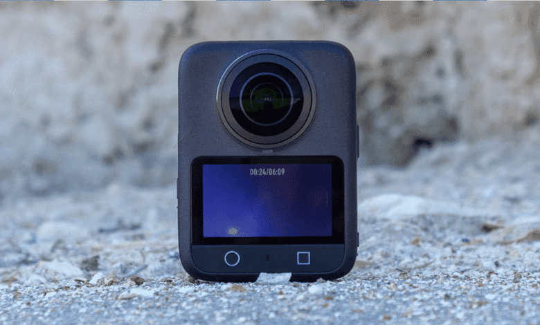 DJI Osmo 360 camera recording on a gray surface.