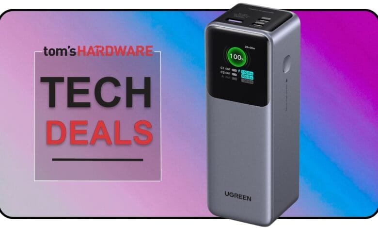 A gray UGREEN power bank with a digital display showing 100% charge, featured in a Tom's Hardware Tech Deals graphic.