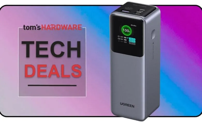 A gray UGREEN power bank with a digital display showing 100% charge, featured in a Tom's Hardware Tech Deals graphic.