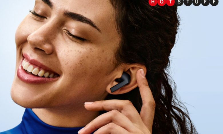 Woman smiling, wearing black Samsung Galaxy Buds 3 FE earbuds.