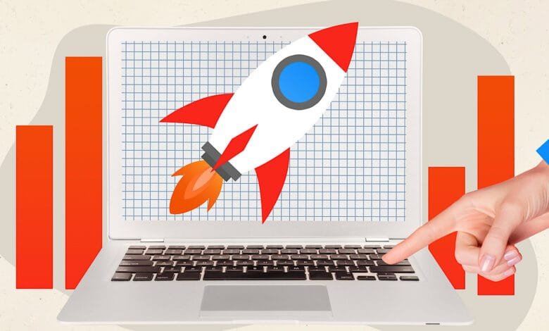 Laptop screen displays a rocket launching, symbolizing growth, alongside rising bar graphs. A hand points to the laptop keyboard.