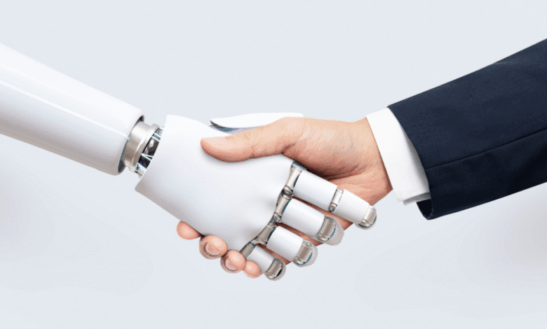 A robotic hand and a human hand shake against a light gray background, symbolizing AI collaboration.